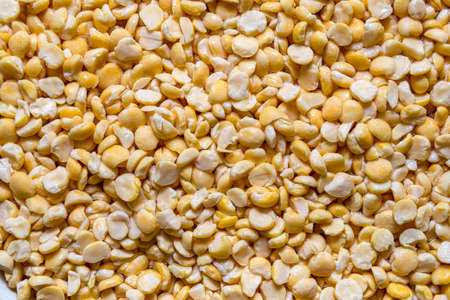 Yellow, dried peas scattered background. food backdrop.の写真素材