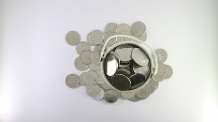 coin on the white bucket isolated on white background