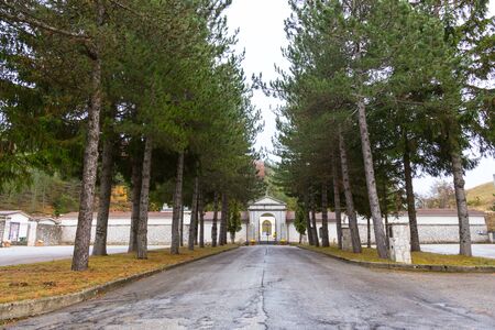 Roccaraso, Abruzzo, Italy. October 13, 2017. Cemetary entrance with tree-lined avenueの写真素材