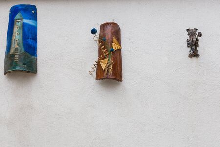 Villetta Barrea, Abruzzo, Italy. October 13, 2017. Artistic decorations attached to the wall of a dwellingの写真素材