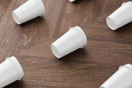 Disposable paper coffee cups on wooden table. 3d renderingの写真素材