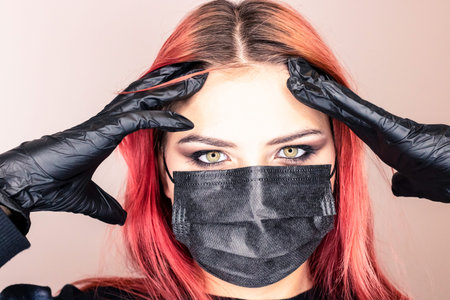 young girl in medical mask, gloves and syringe. Fashion for medical dressings among young people.