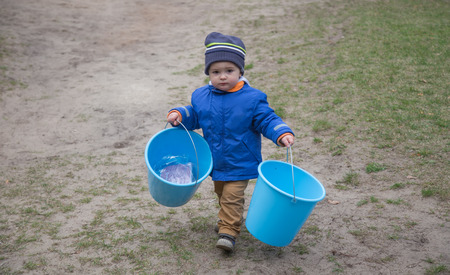 pretty little baby boy with bucketsの写真素材