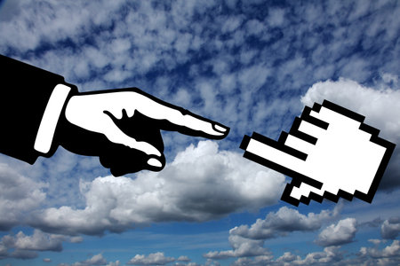 Conceptual image of human hand pointing at something on sky backgroundの写真素材