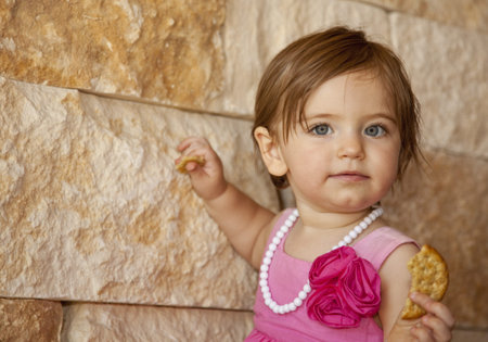 Baby Girl With Crackerの写真素材