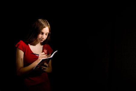 Dear diary - cute teenage girl writing in her diary 