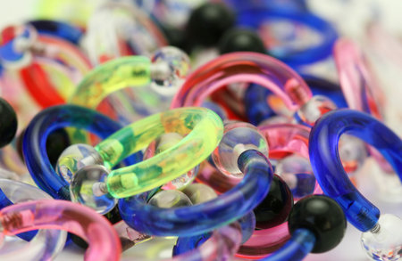 A bulk pile of acrylic horseshoes used in body piercing.
