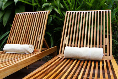 Lounge chairs surround a pool at a five star resortの写真素材