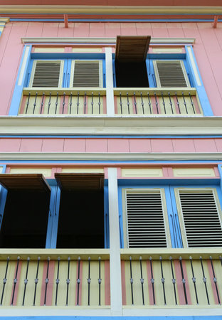 A colorful house with some of the shutters openedの写真素材