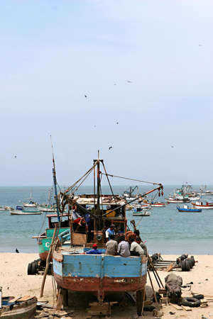 An old ship on the beach is under repairの写真素材