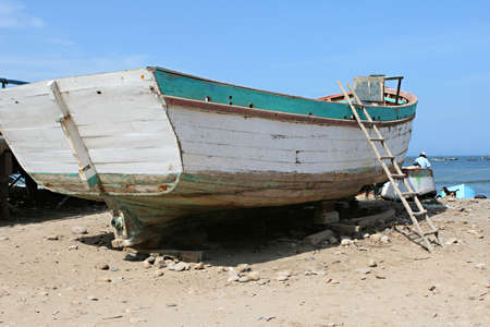 A wooden fishing boat on the beach in Peruの写真素材