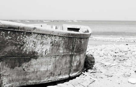 A colorful wooden fishing boat on the beach in Peruの写真素材