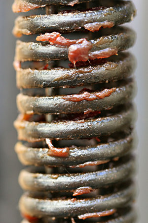 A macro shot of a metal spring with greaseの写真素材