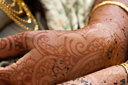 Henna tattooed arms on an Indian Bride