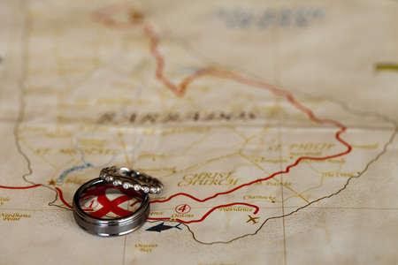 A close-up shot of a beautiful wedding rings on a map of Barbadosの写真素材