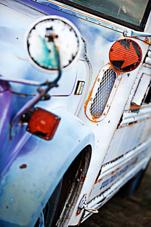 An orange arrow turn-signal on an old school busの写真素材