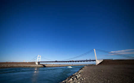 Icebergs float out to sea under a bridge at Jokulsarlon lake, Icelandの写真素材