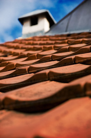 Roof with red tiles and chimney