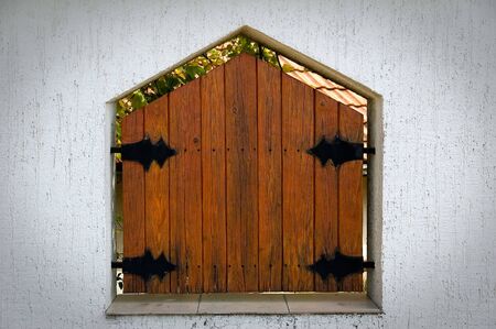 Decorative window in the wall on the fenceの写真素材
