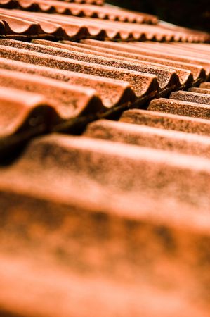 Roof with red tiles and chimneyの写真素材