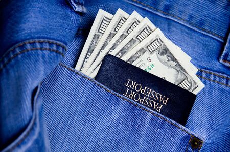 Passport with American dollars in the pocket of jeansの写真素材