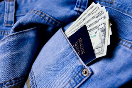 Passport with American dollars in the pocket of jeansの写真素材
