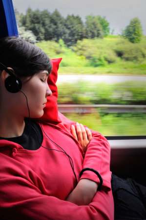 Travelling young woman - girl sleep in the busの写真素材