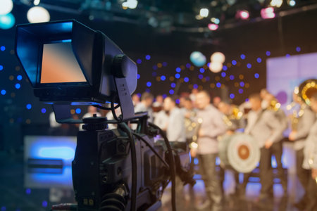 Television studio with camera and lights - recording TV show. Shallow depth of field - focus on...