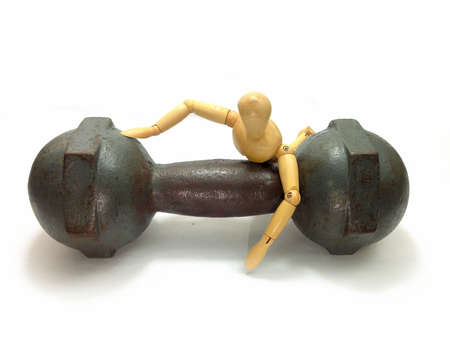 dumbbell and Wooden person on isolated white background.の写真素材