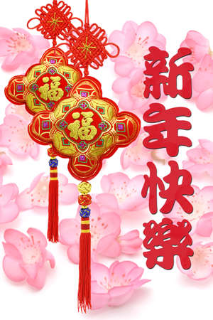 Chinese new year greeting and traditional ornament on foral backgroundの写真素材