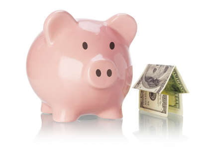Piggy bank and money house on white backgoundの写真素材
