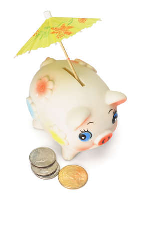 Saving for raining days - Cute piggy bank with colorful umbrella and US coins on white backgroundの写真素材