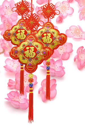 Chinese new year traditional ornaments on cherry blossom backgroundの写真素材