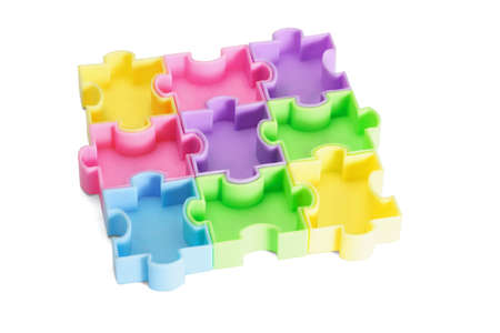 Multicolor plastic jigsaw puzzles on white backgroundの写真素材
