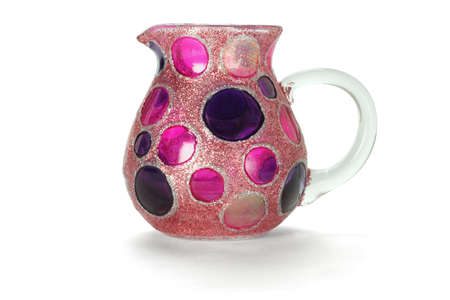 Colorful glass jug with circular patterns on white backgroundの写真素材