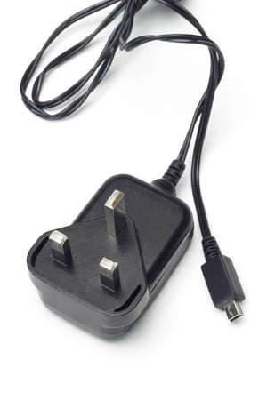Mobile phone battery charger and adapter on white backgroundの写真素材