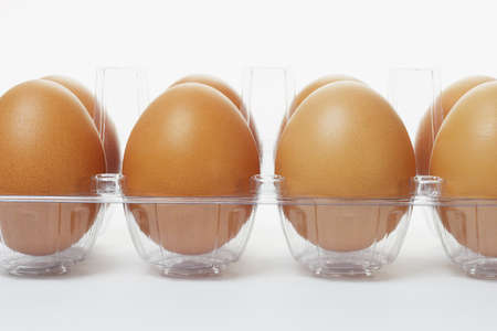 Close up of fresh eggs in clear plastic trayの写真素材