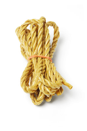 Bundle of rope tied with rubber band on white background