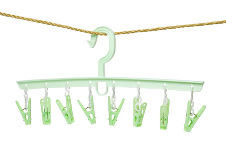 Plastic clothes hanger with hanging pegs on white backgroundの写真素材
