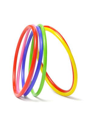 multicolor plastic bangles arranged on white backgroundの写真素材
