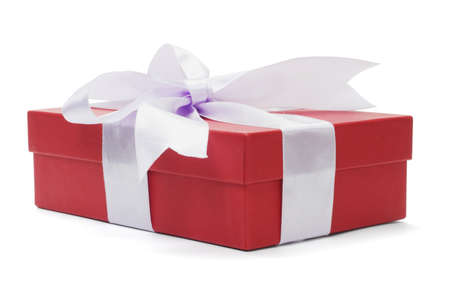 Red gift box with bow ribbon on white backgroundの写真素材