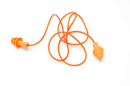 Orange color ear plugs on white backgroundの写真素材