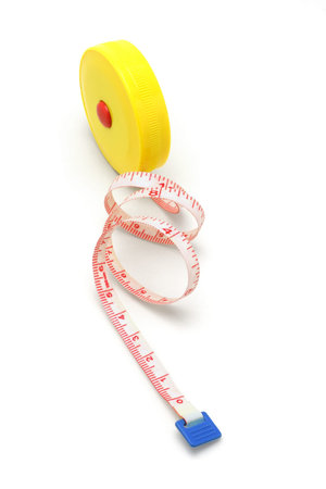 Round plastic tape measure standing on white background