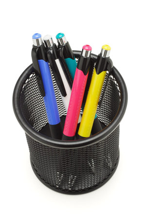 Multicolor ball point pens in black container on white