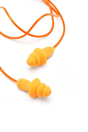 Orange ear plugs isolated on white backgroundの写真素材