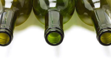 Close up of empty wine bottles lying  on white backgroundの写真素材