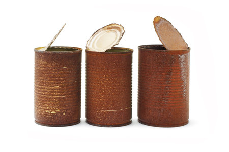 Rusty tin cans arranged on white background