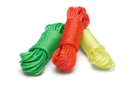 Three bundles of colorful nylon ropes on white background