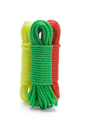 Three bundles of colorful nylon ropes standing together on white background