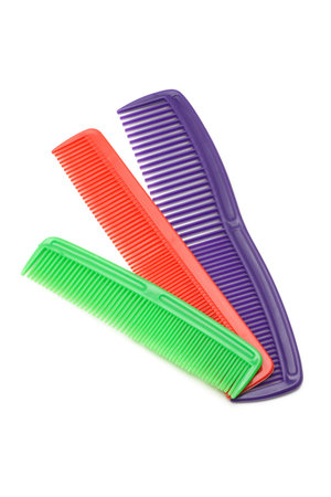 Three colorful plastic combs on white background